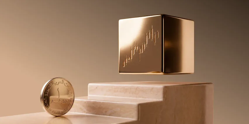 A gold cube etched with a candlestick chart hovers above stone steps, with a one-dirham coin standing at the base.