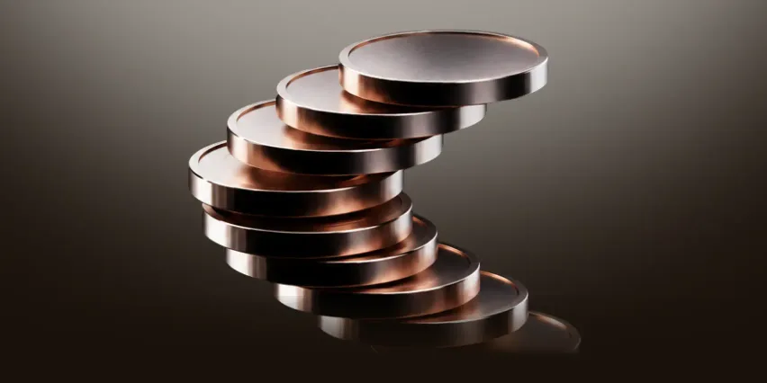 Stack of copper coins leaning in a spiral, illustrating a monthly SIP building up over time