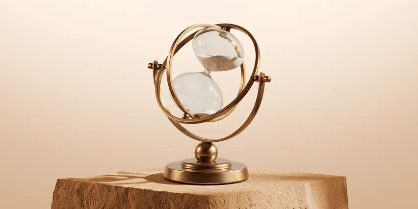 Brass hourglass suspended in gimbal rings on a sandstone block, sand running through against a warm beige background