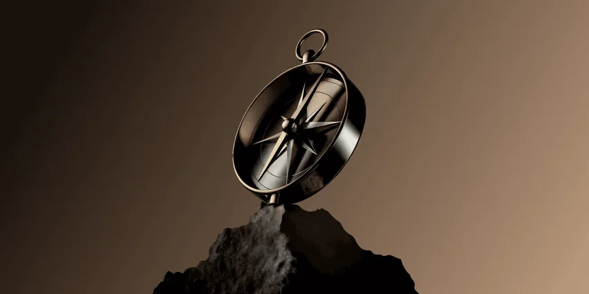 A 3D-rendered bronze compass balanced on a dark rocky outcrop against a warm brown gradient background, its ornate star-shaped rose and needle catching the light.