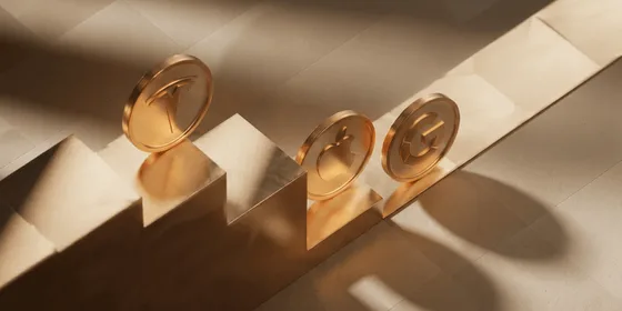 Gold coins engraved with the Tesla, Apple, and Google logos standing on golden steps, representing US stocks available to UAE investors.
