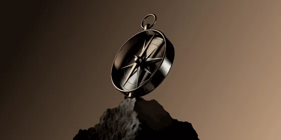 A 3D-rendered bronze compass balanced on a dark rocky outcrop against a warm brown gradient background, its ornate star-shaped rose and needle catching the light.